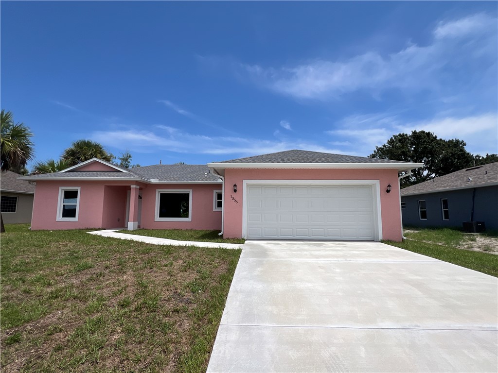 a front view of a house with yard and garage