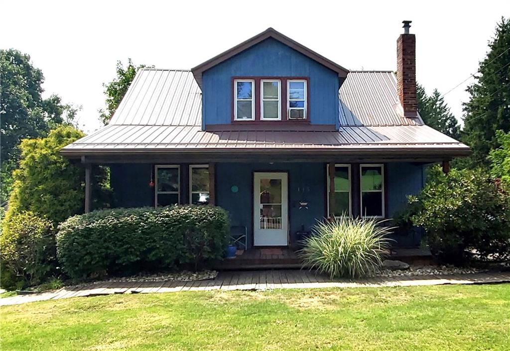 a front view of a house with a yard and porch