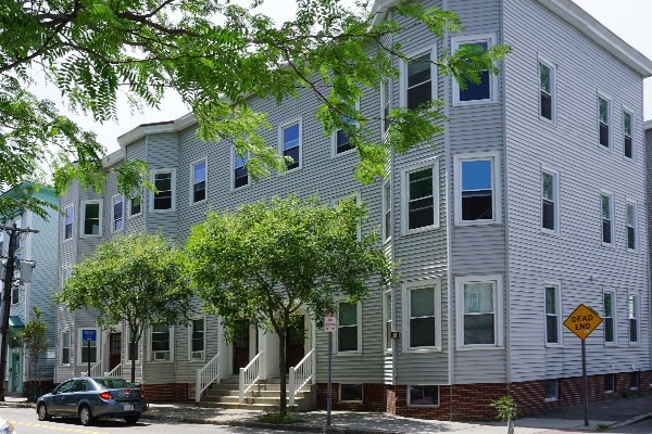 a front view of a building with trees