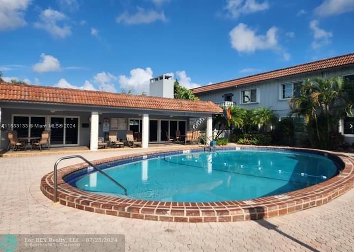 a view of a house with swimming pool and a porch