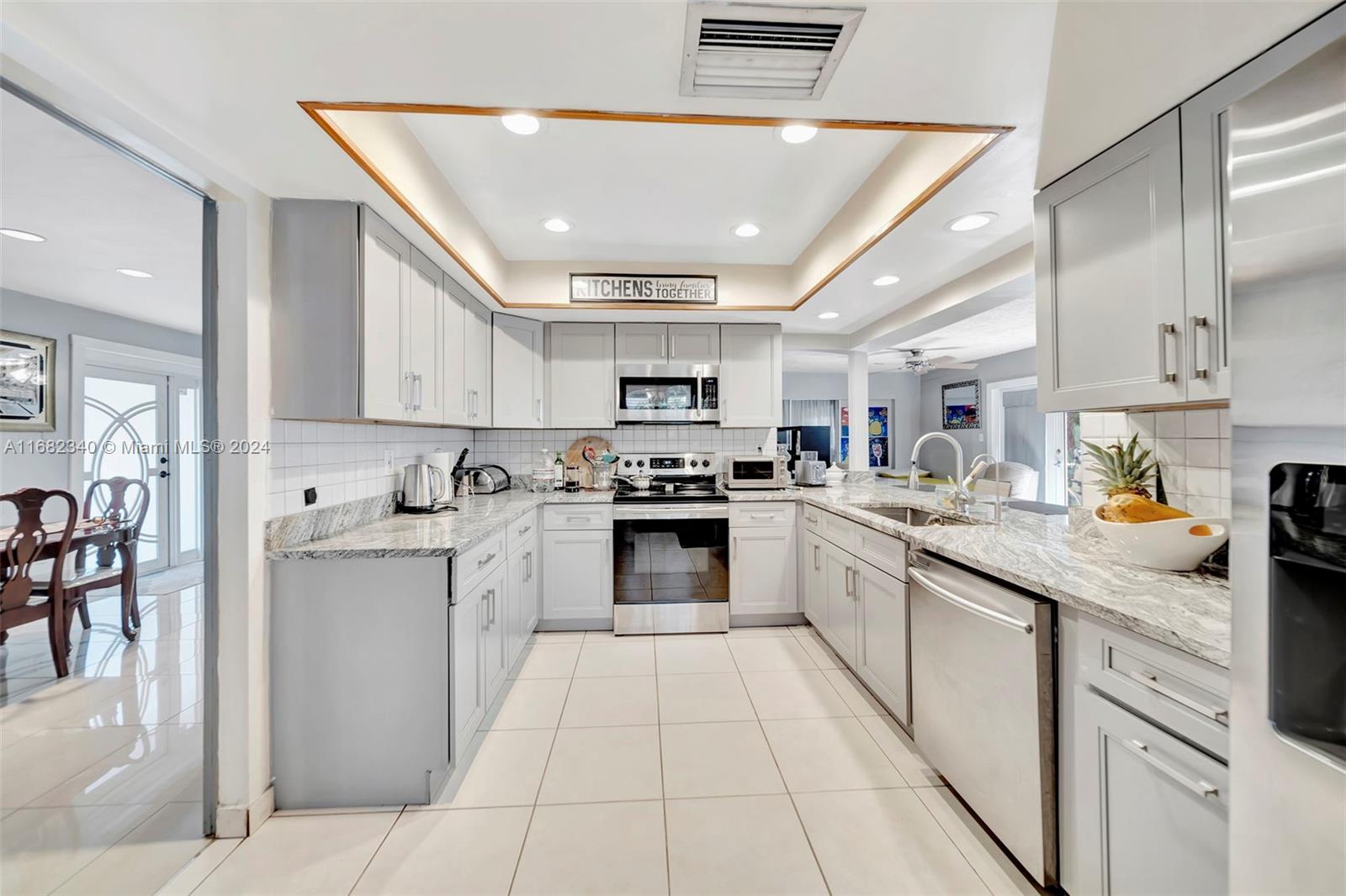 a kitchen with stainless steel appliances granite countertop a stove and cabinets