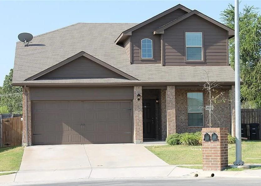 a front view of a house with garage