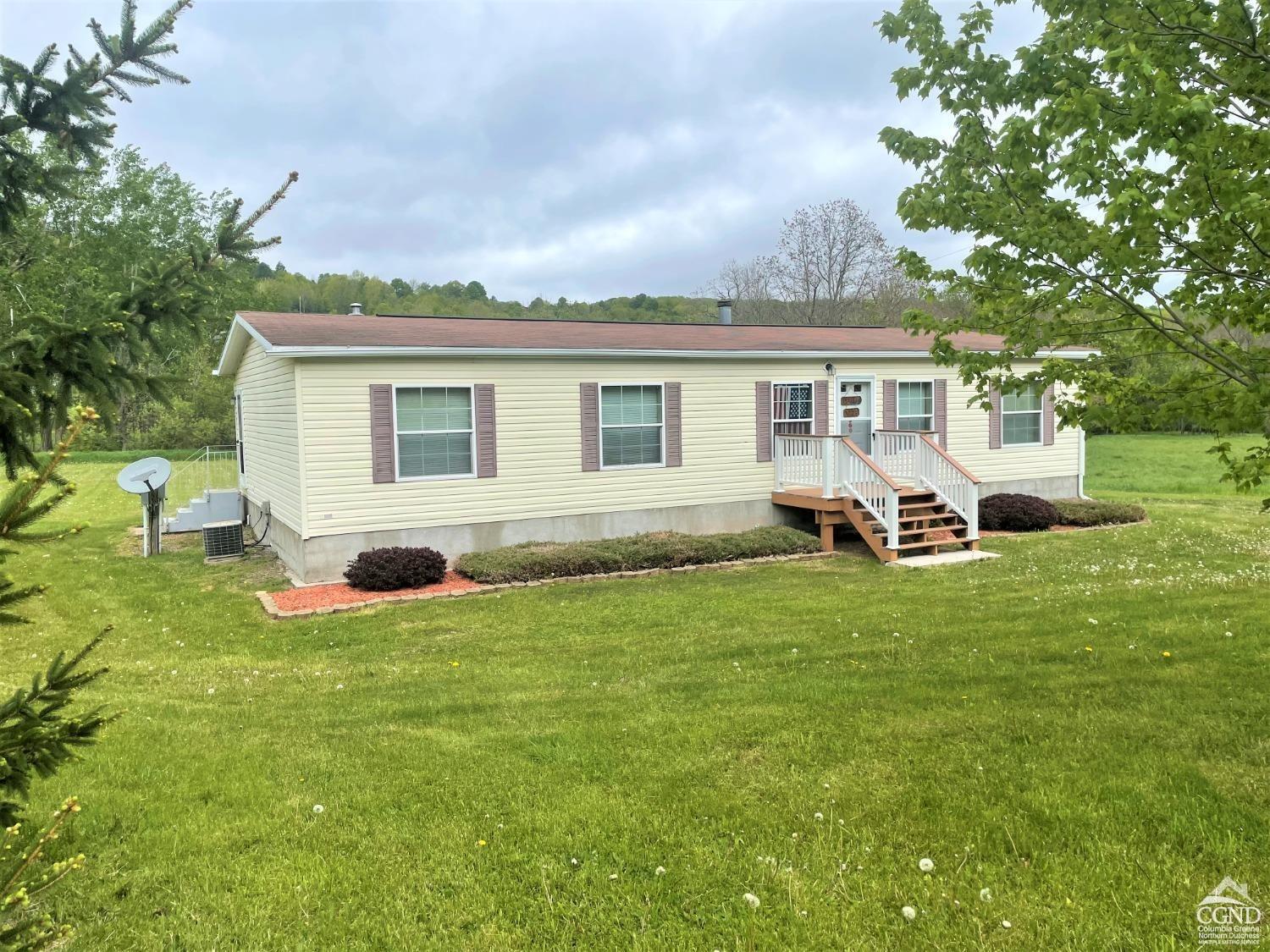 a view of a house with backyard and porch