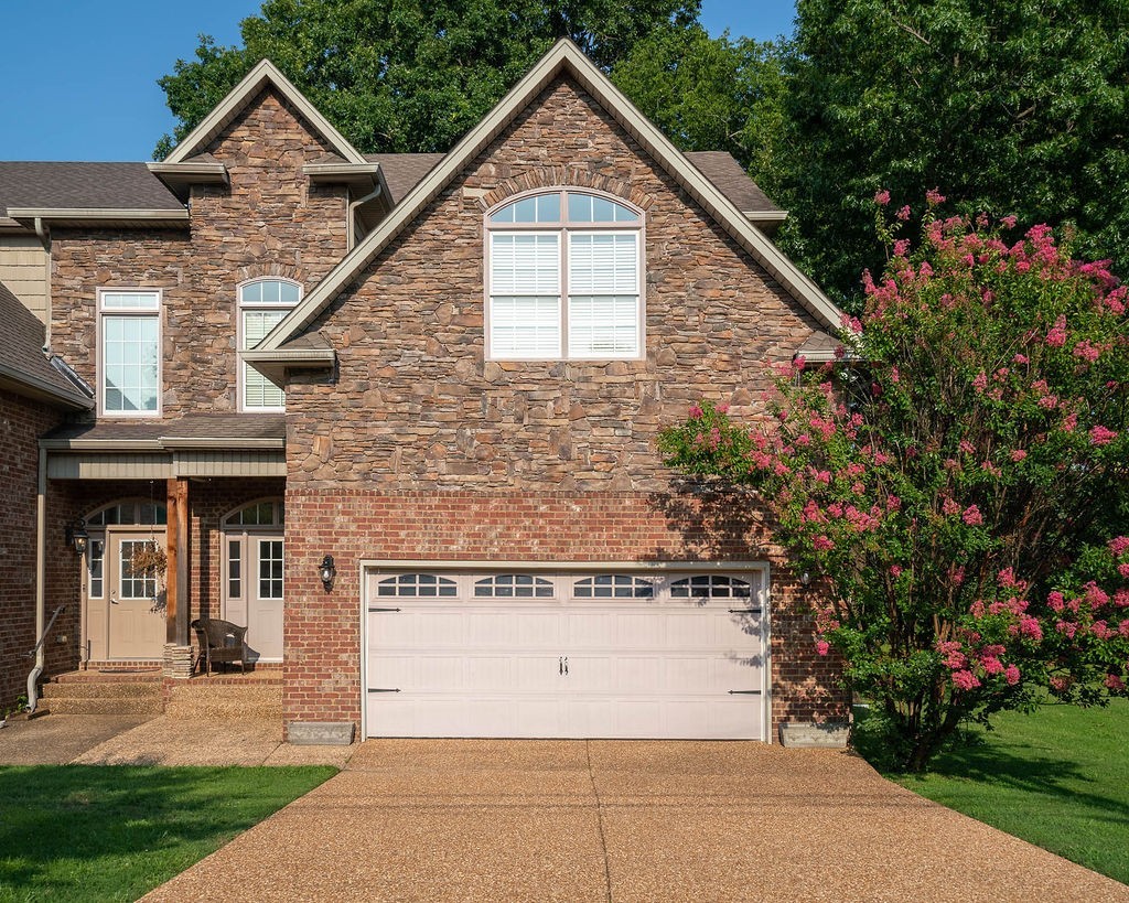 a view of a house with a yard and garden