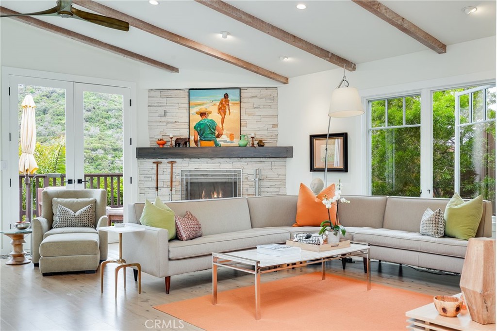 a living room with furniture fireplace and a large window