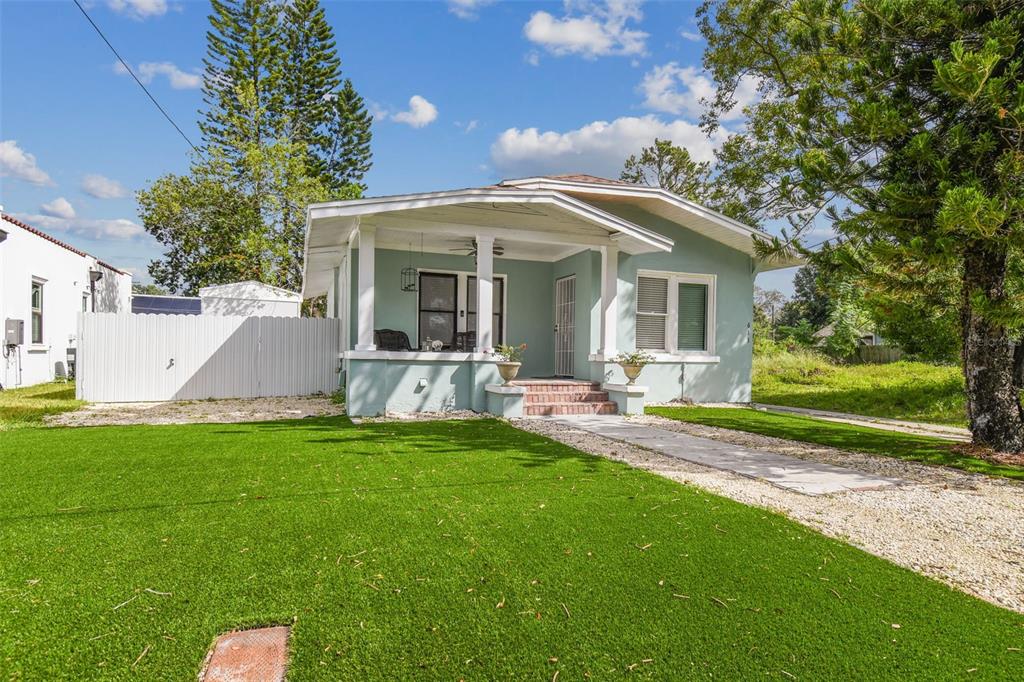 a view of a house with backyard and porch