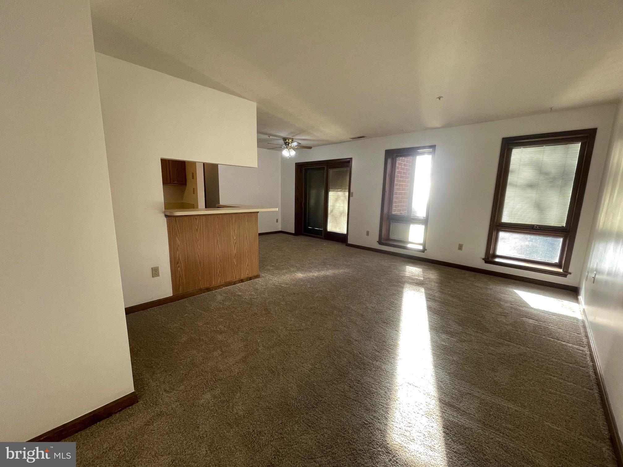 a view of a livingroom with wooden floor and a window