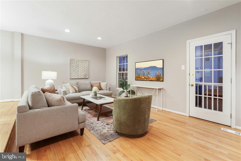 a living room with fireplace furniture and a wooden floor