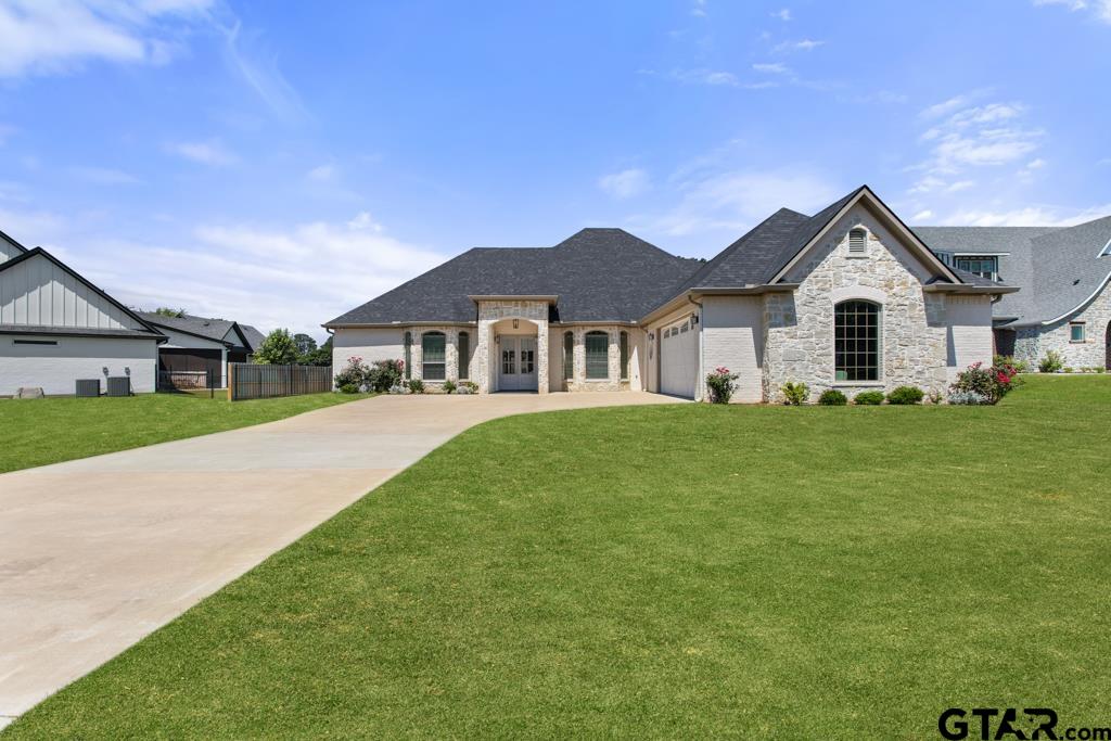 a front view of house with yard and green space