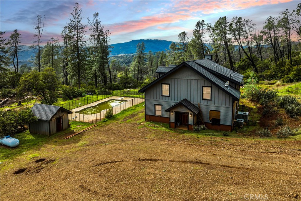 a view of a house with a yard and roof