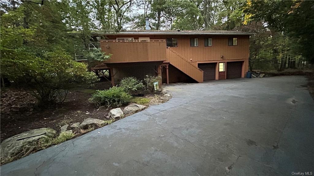 a view of a house with a yard and garage