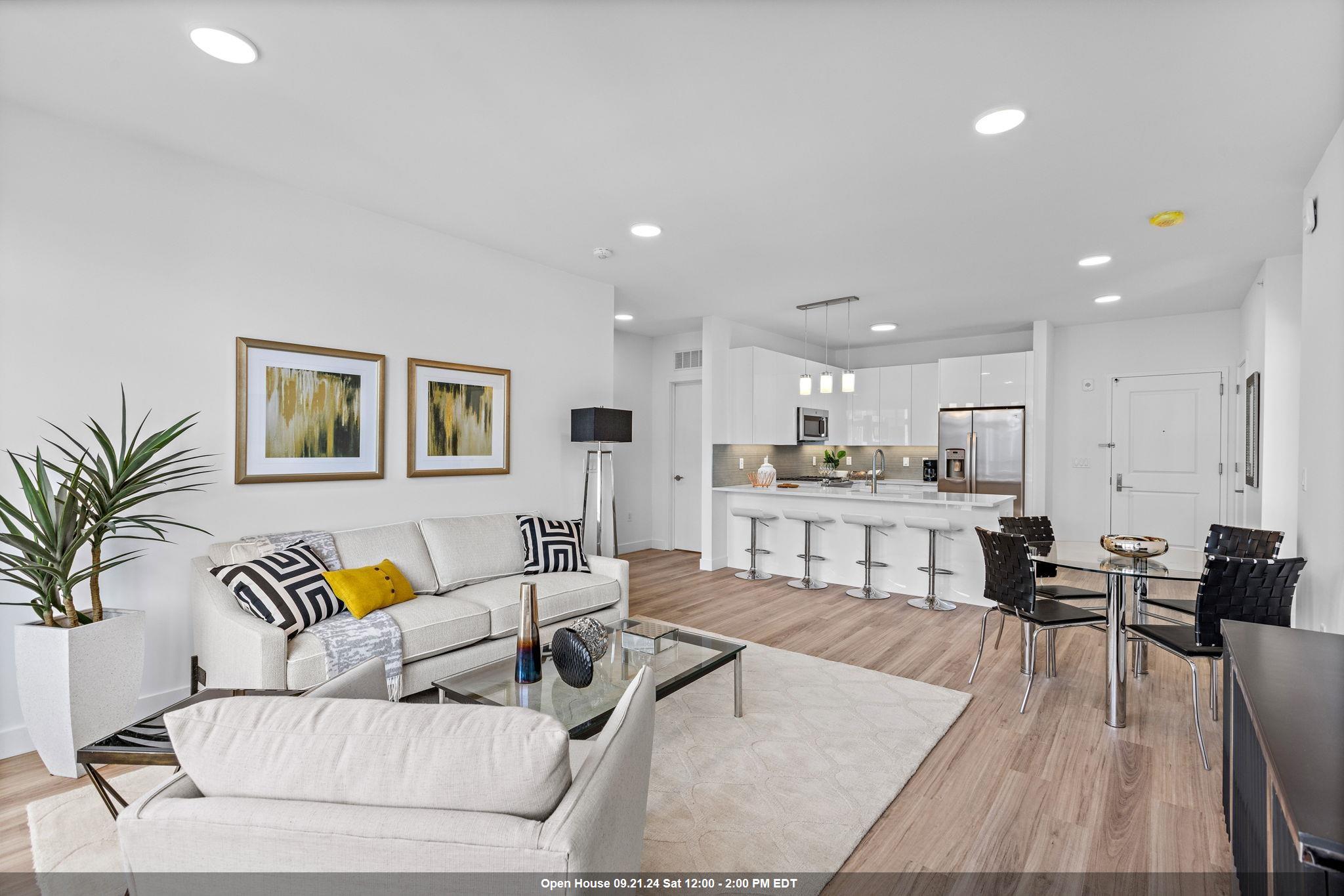 a living room with furniture and kitchen view