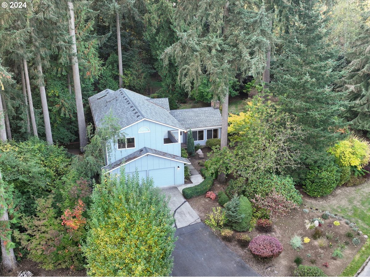 a aerial view of a house with a yard and fountain in middle