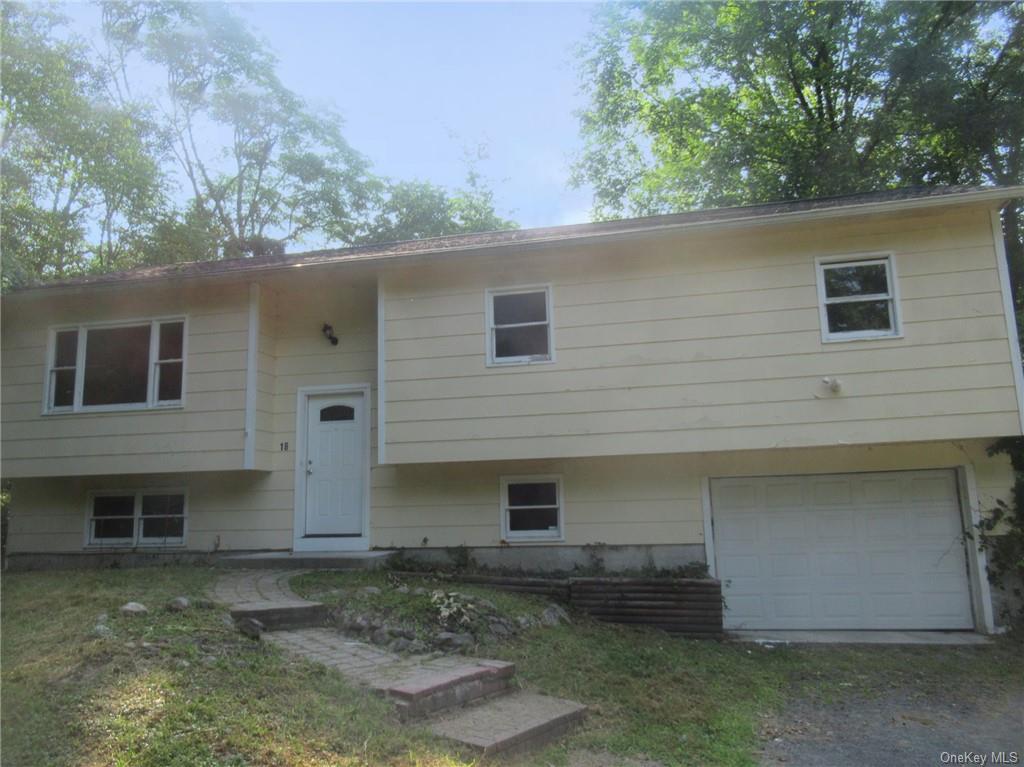 Split foyer home featuring a garage