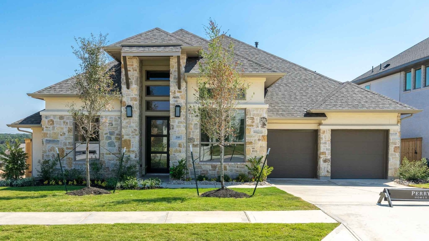 a front view of a house with a yard