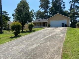 a front view of house with yard and trees