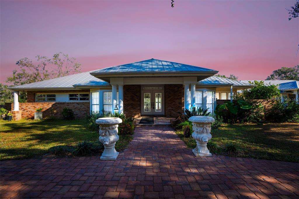 a view of a house with backyard sitting area and garden