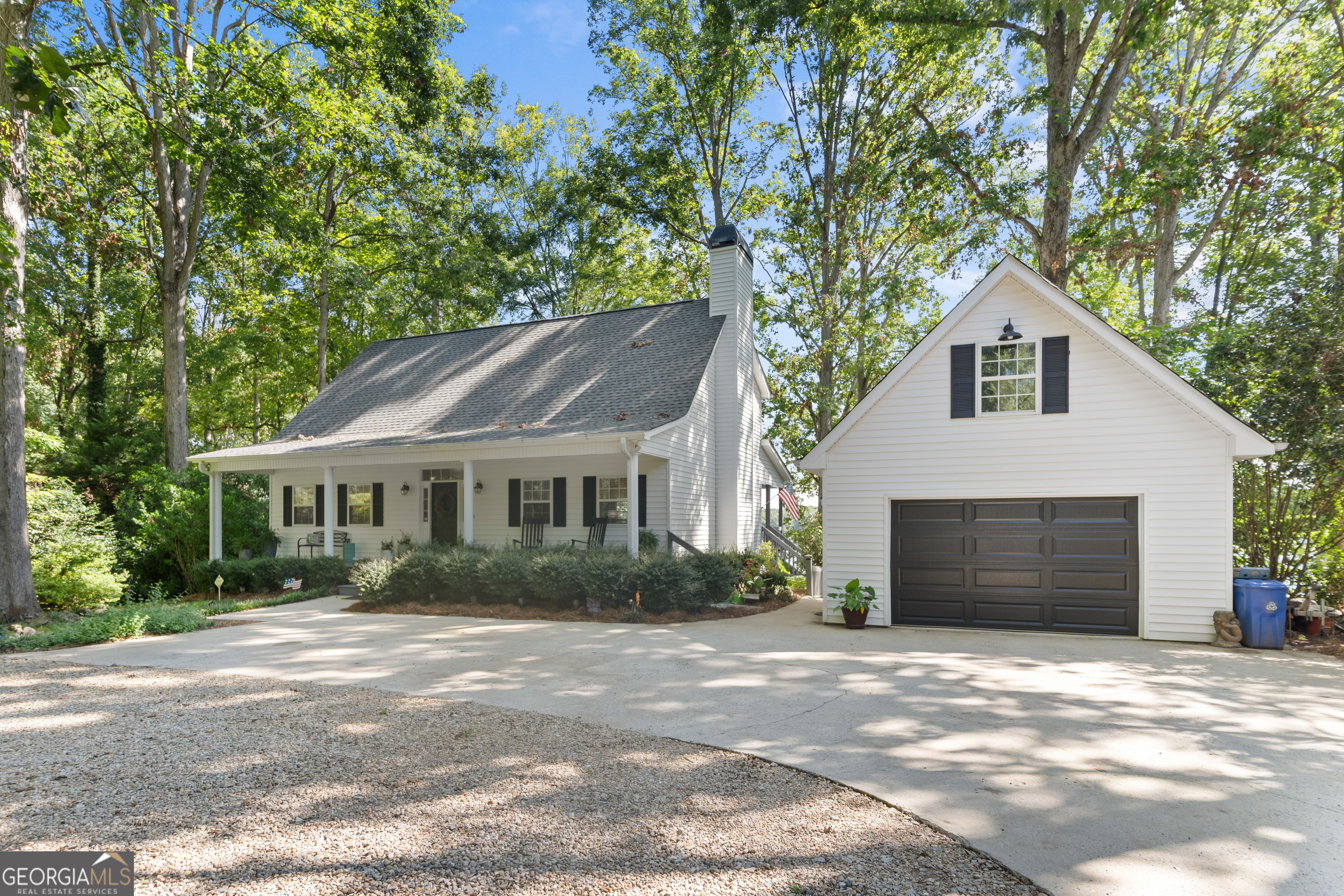 a front view of house with yard and trees around