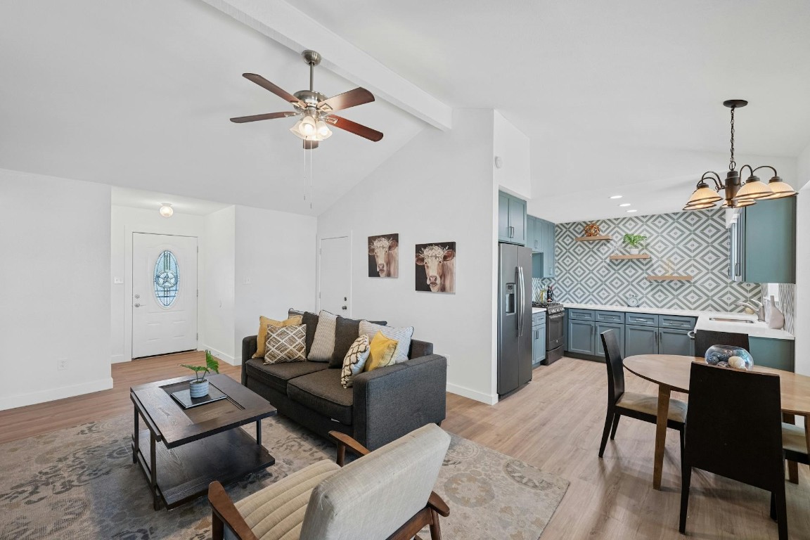 a living room with furniture a ceiling fan and a rug