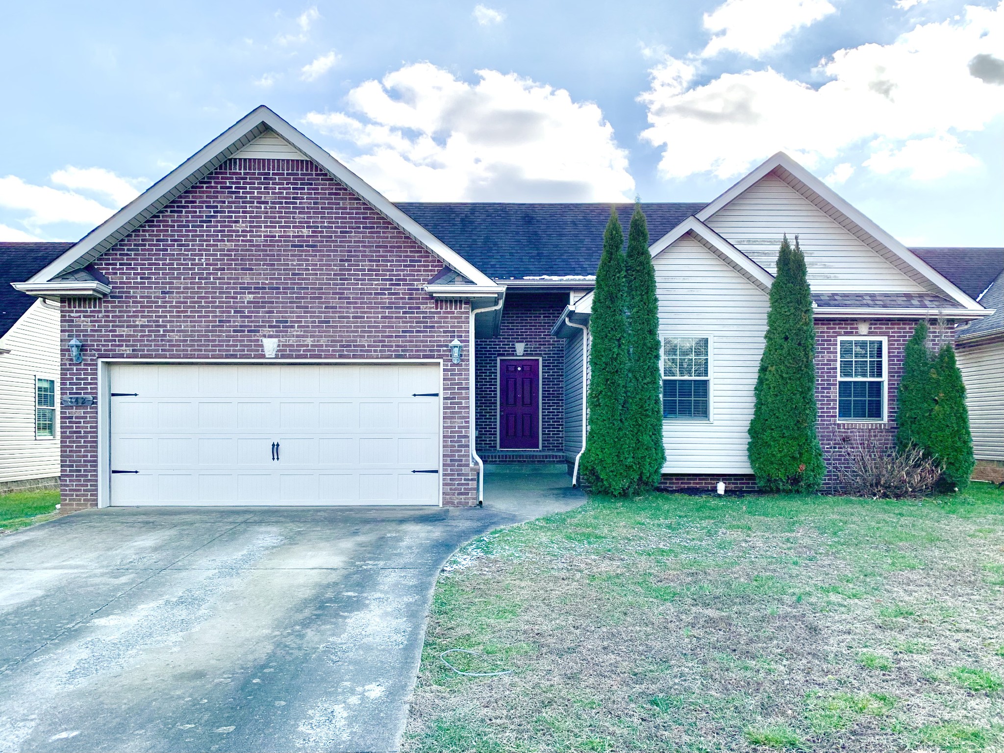 a view of a house with yard and a garage