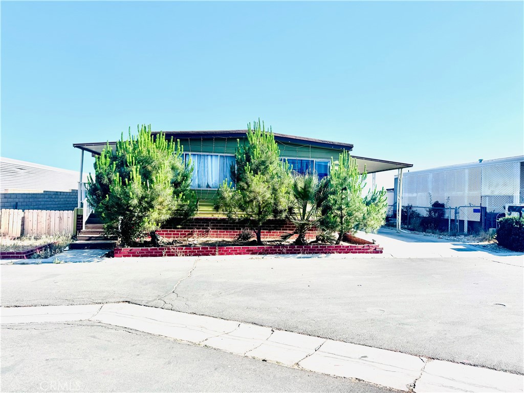 a view of a house with a yard and plants