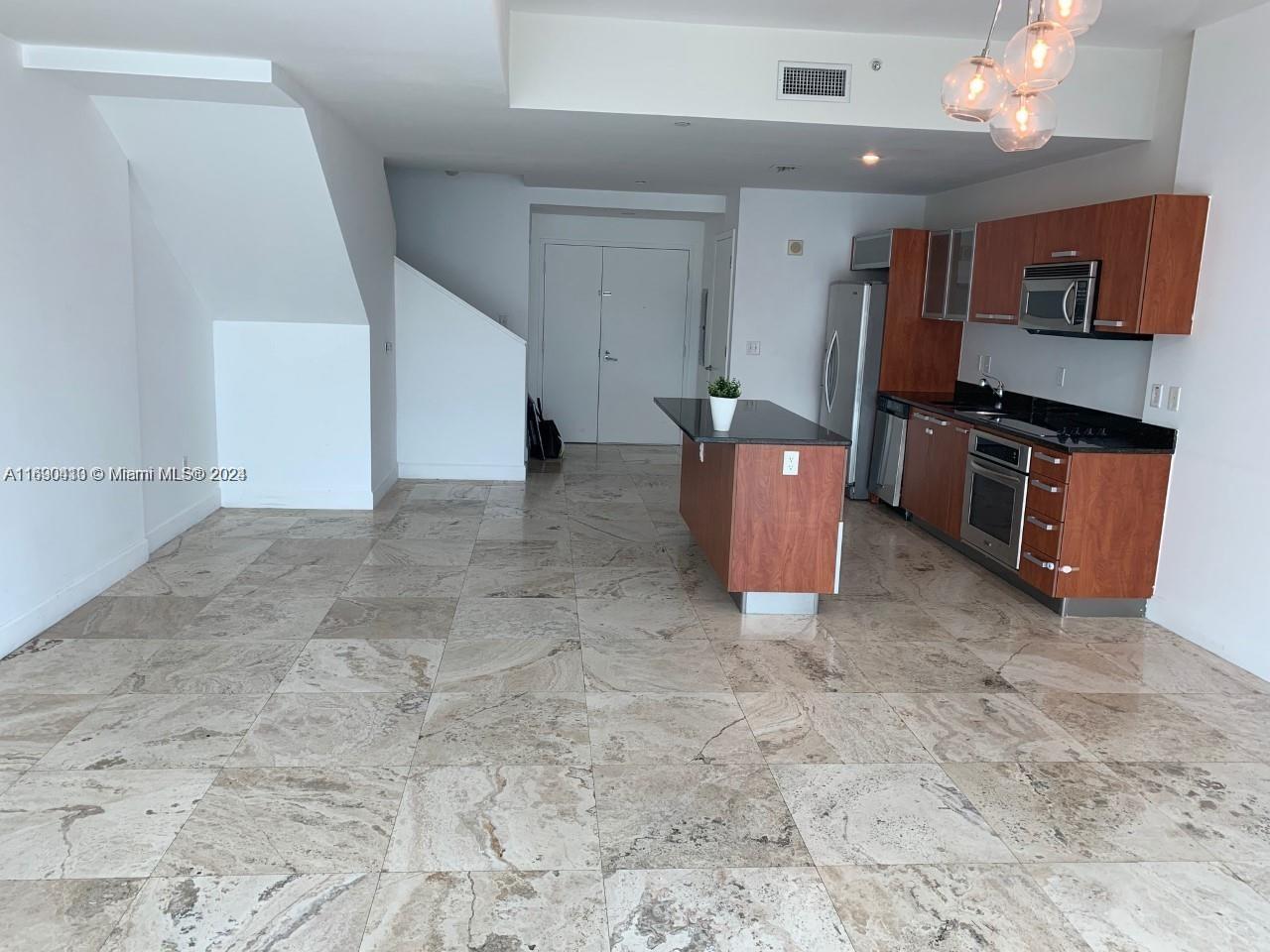 a view of kitchen with stainless steel appliances granite countertop a stove a sink and a refrigerator