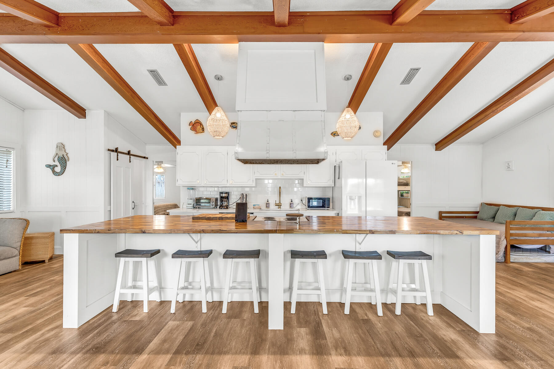 a large kitchen with a table and chairs