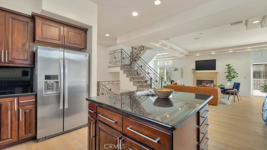 a kitchen with stainless steel appliances granite countertop a sink a oven and a refrigerator