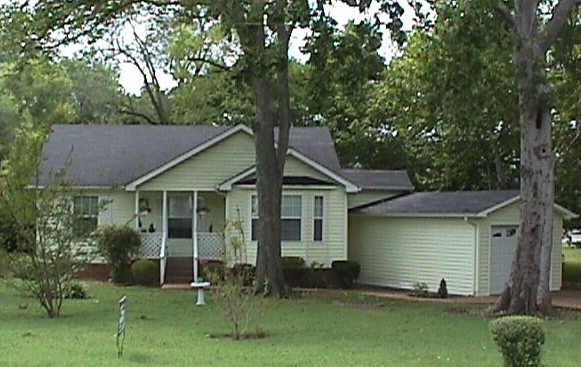 a house that has a tree in front of it