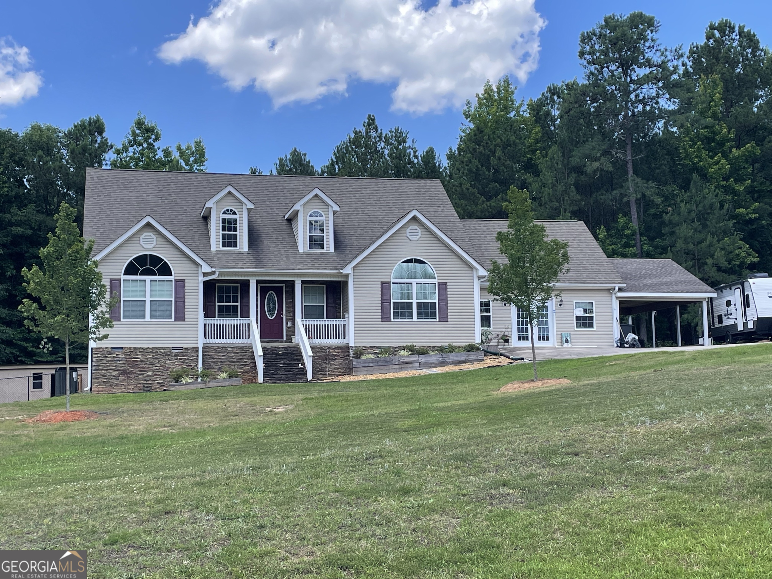 a front view of a house with a garden