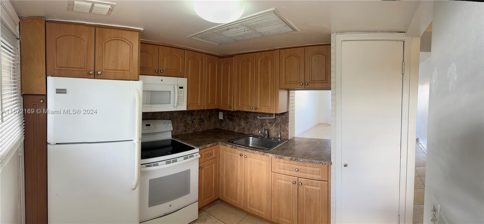 a kitchen with stainless steel appliances granite countertop a refrigerator sink and cabinets