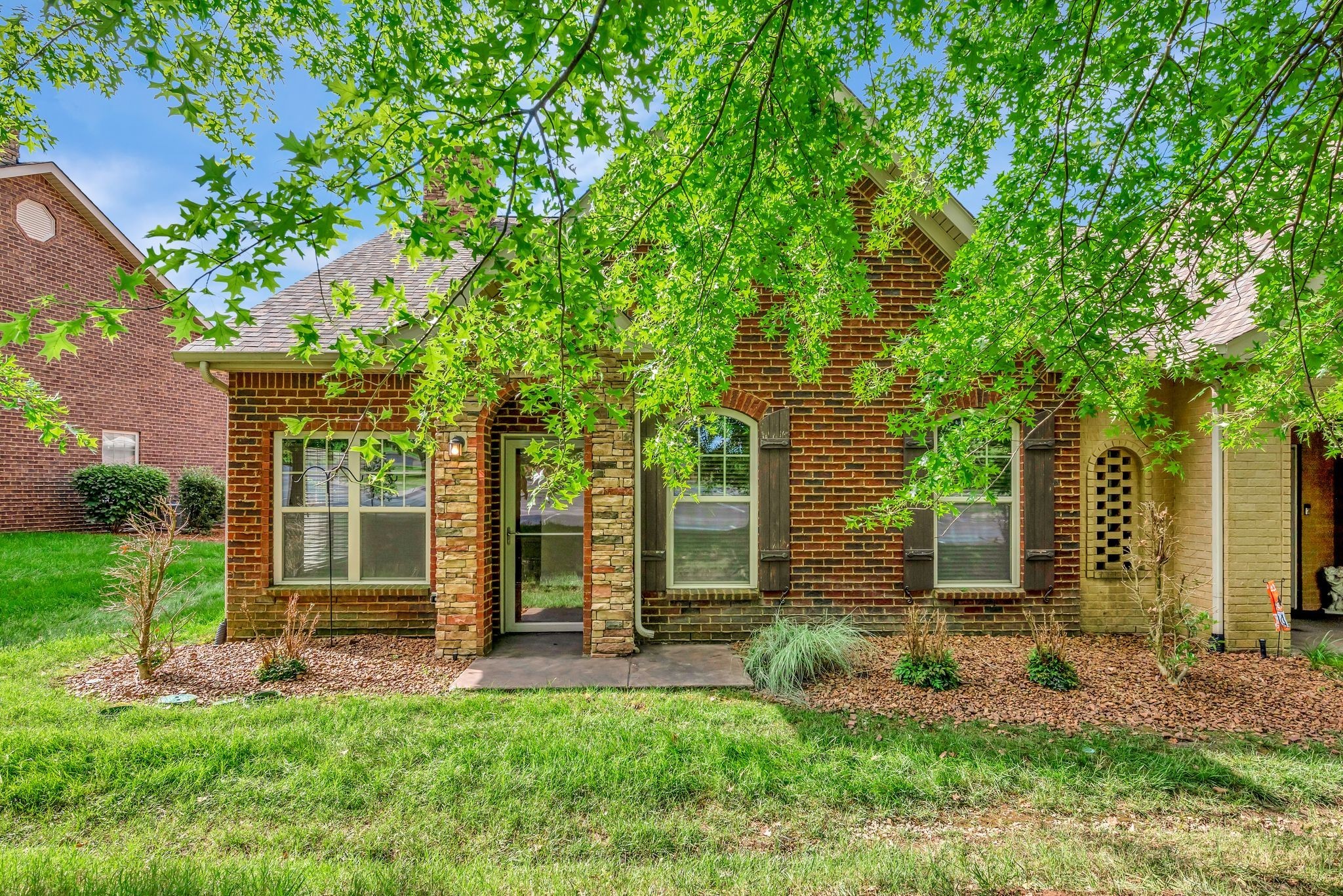 front view of a house with a tree