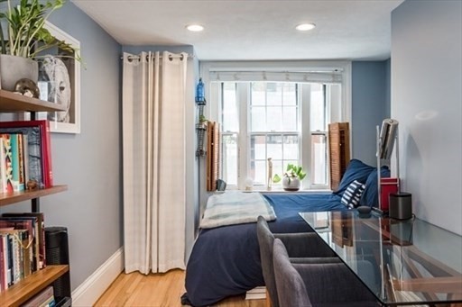 a view of a living room with furniture and a large window