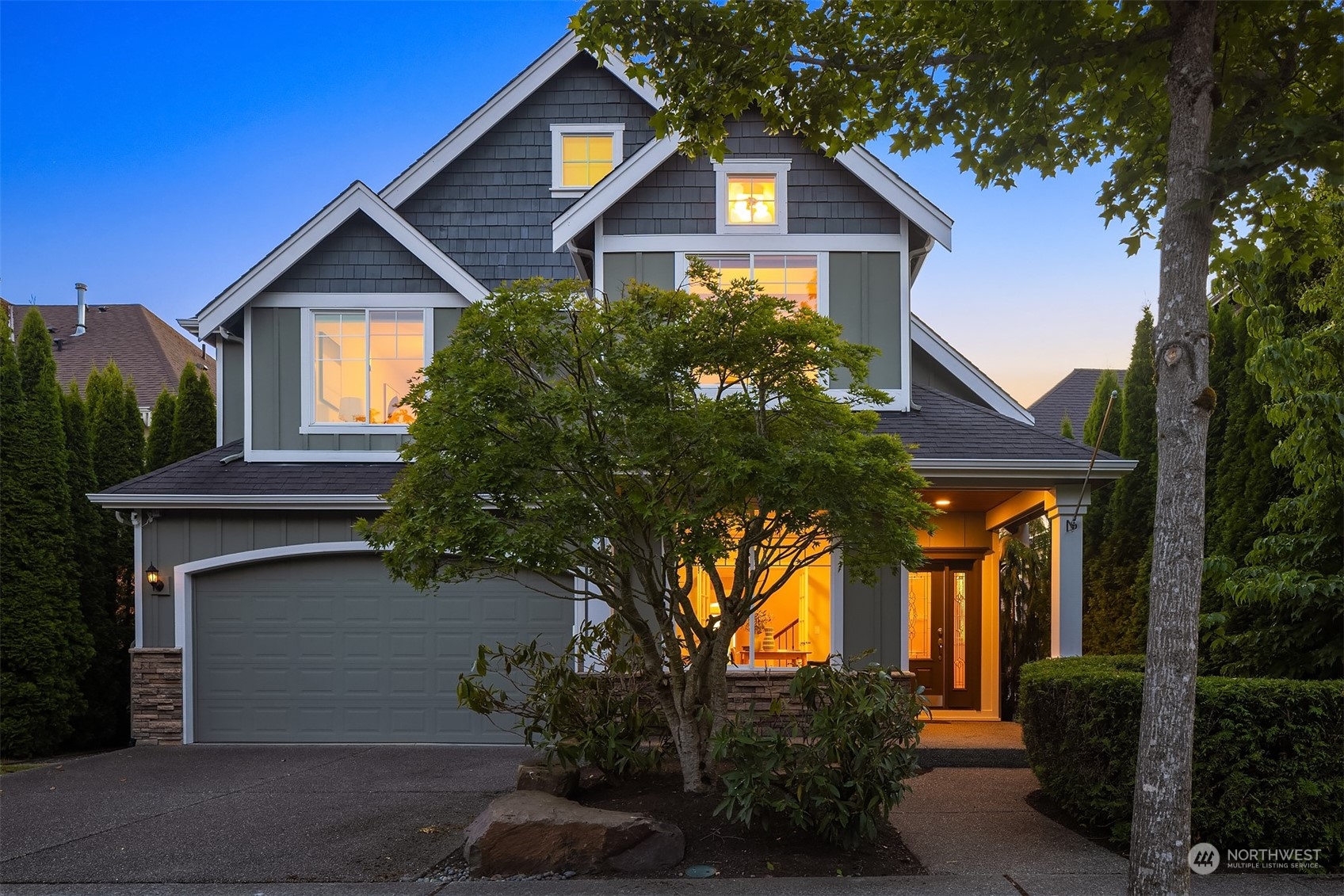 a house that has a tree in front of it