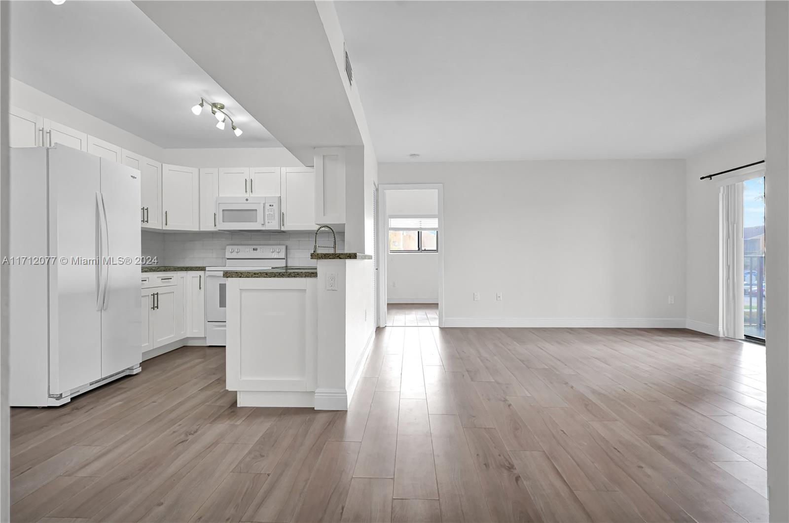 a view of kitchen with wooden floor