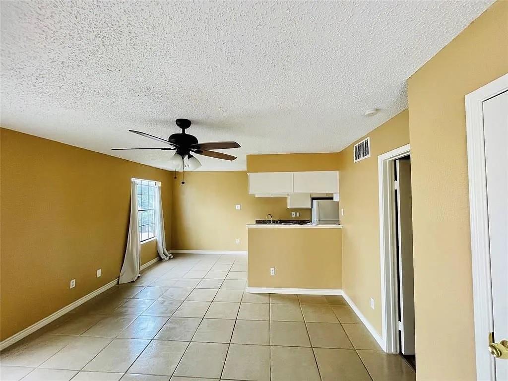 a view of a kitchen with a sink dishwasher and a refrigerator