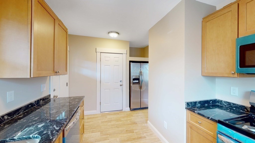 a kitchen with granite countertop a sink and a stove top oven