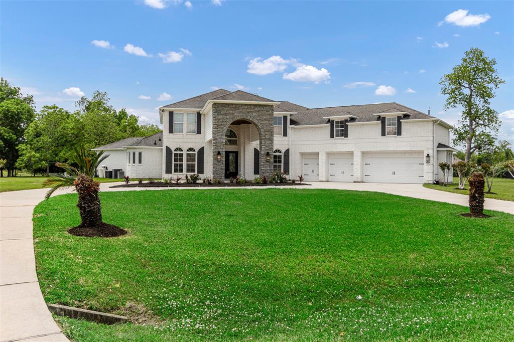 a front view of a house with a garden and yard