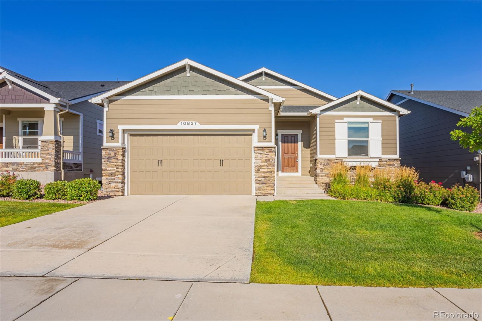 a front view of a house with a yard and garage