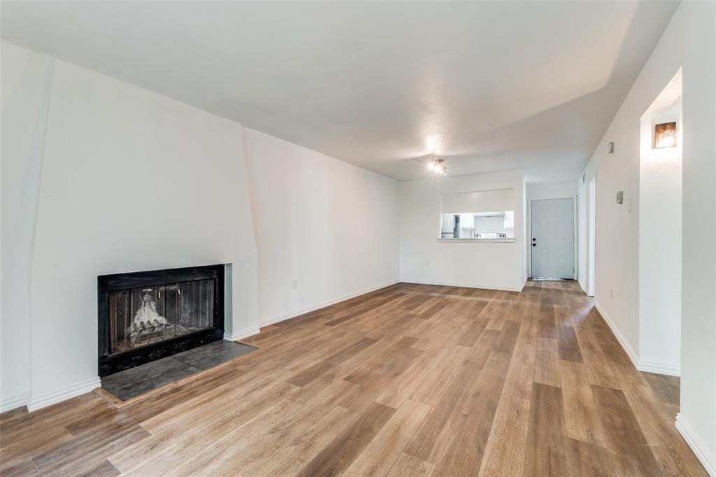 a view of an empty room and wooden floor