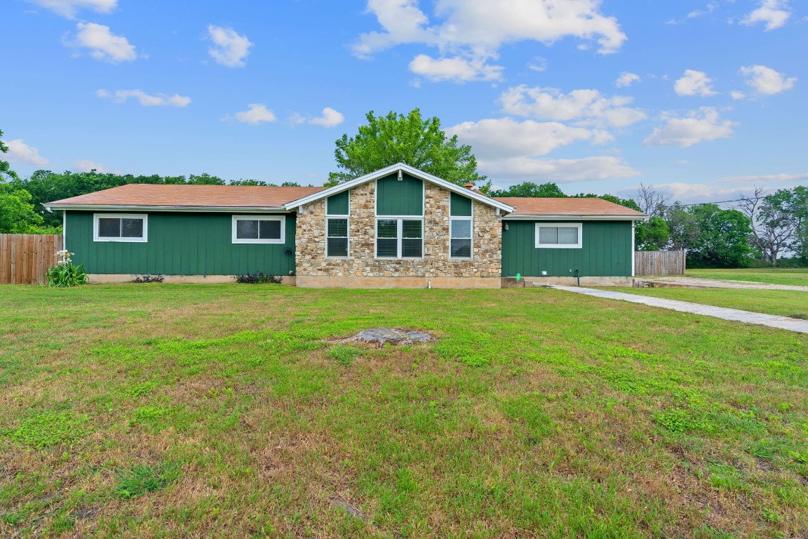 a front view of house with yard and green space