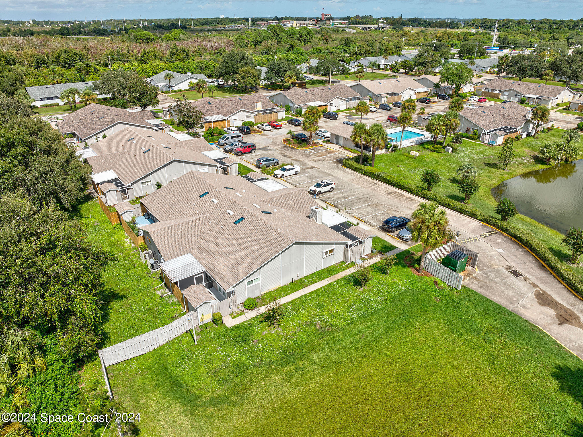 an aerial view of residential houses with outdoor space and river