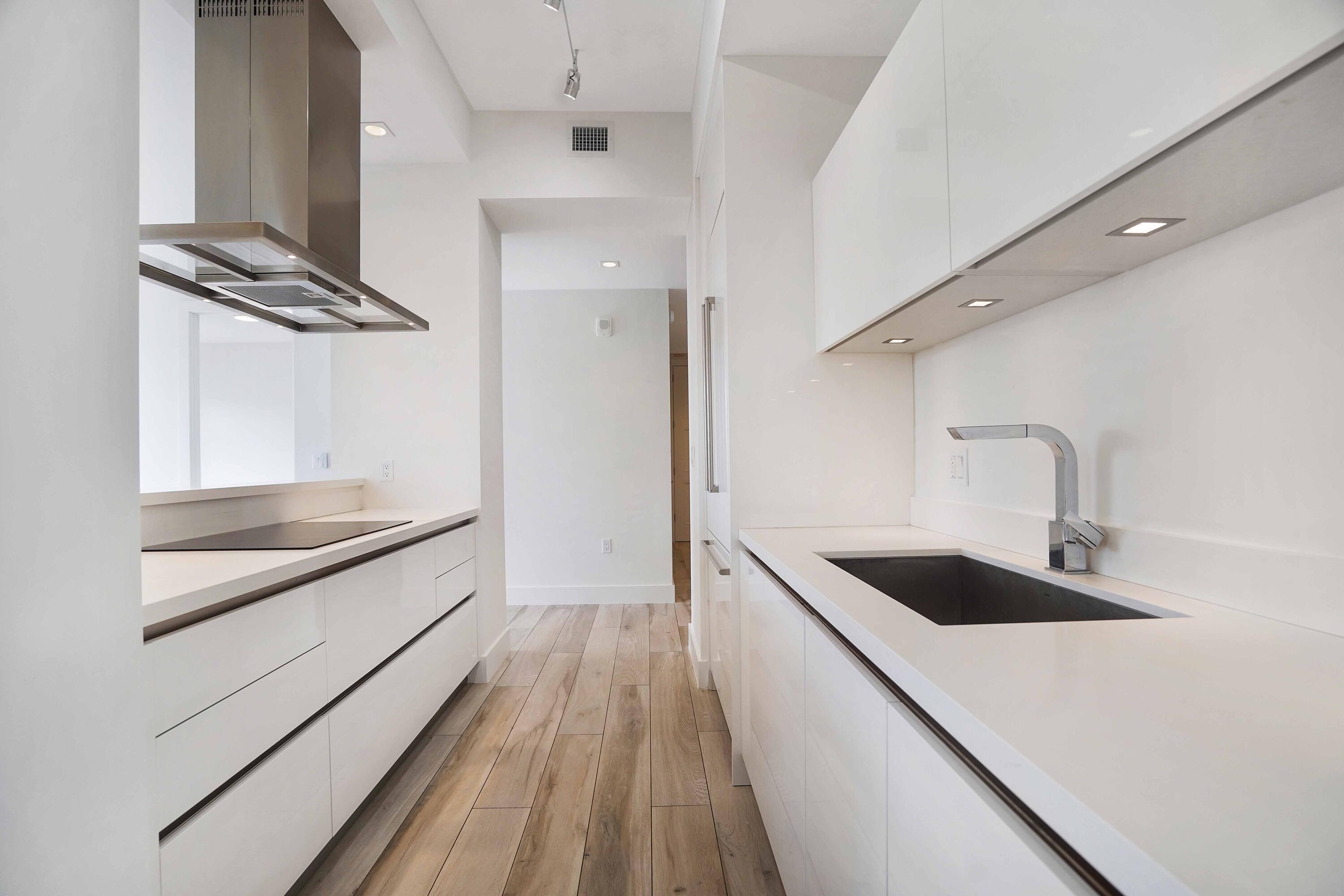 a kitchen with granite countertop a sink and a stove top oven