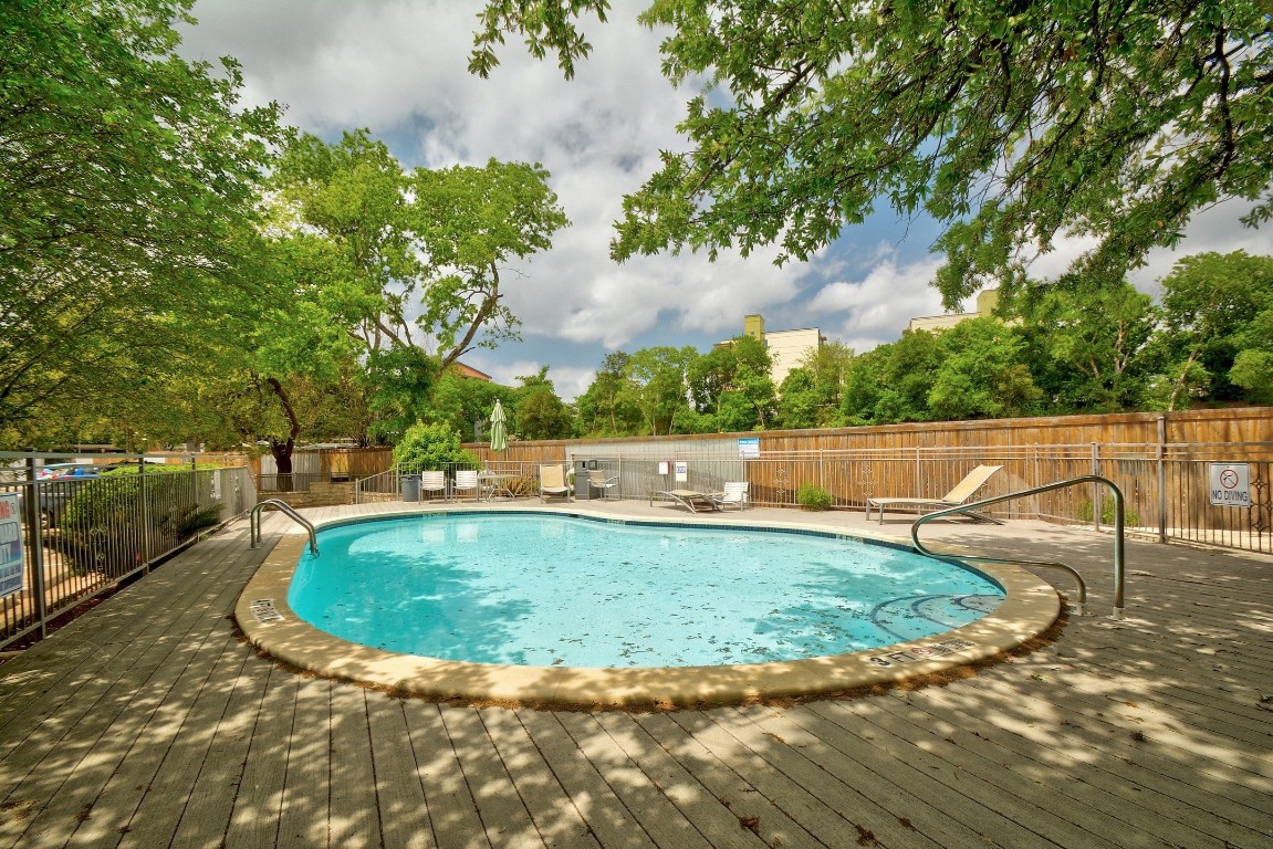 a view of a swimming pool with a yard