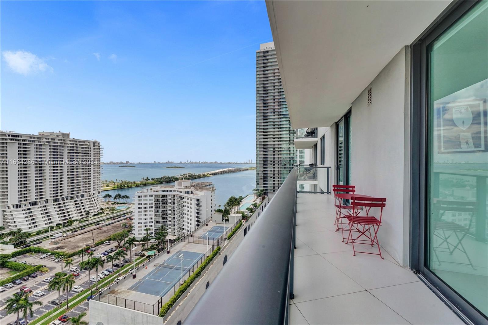 a balcony with outdoor seating and city view