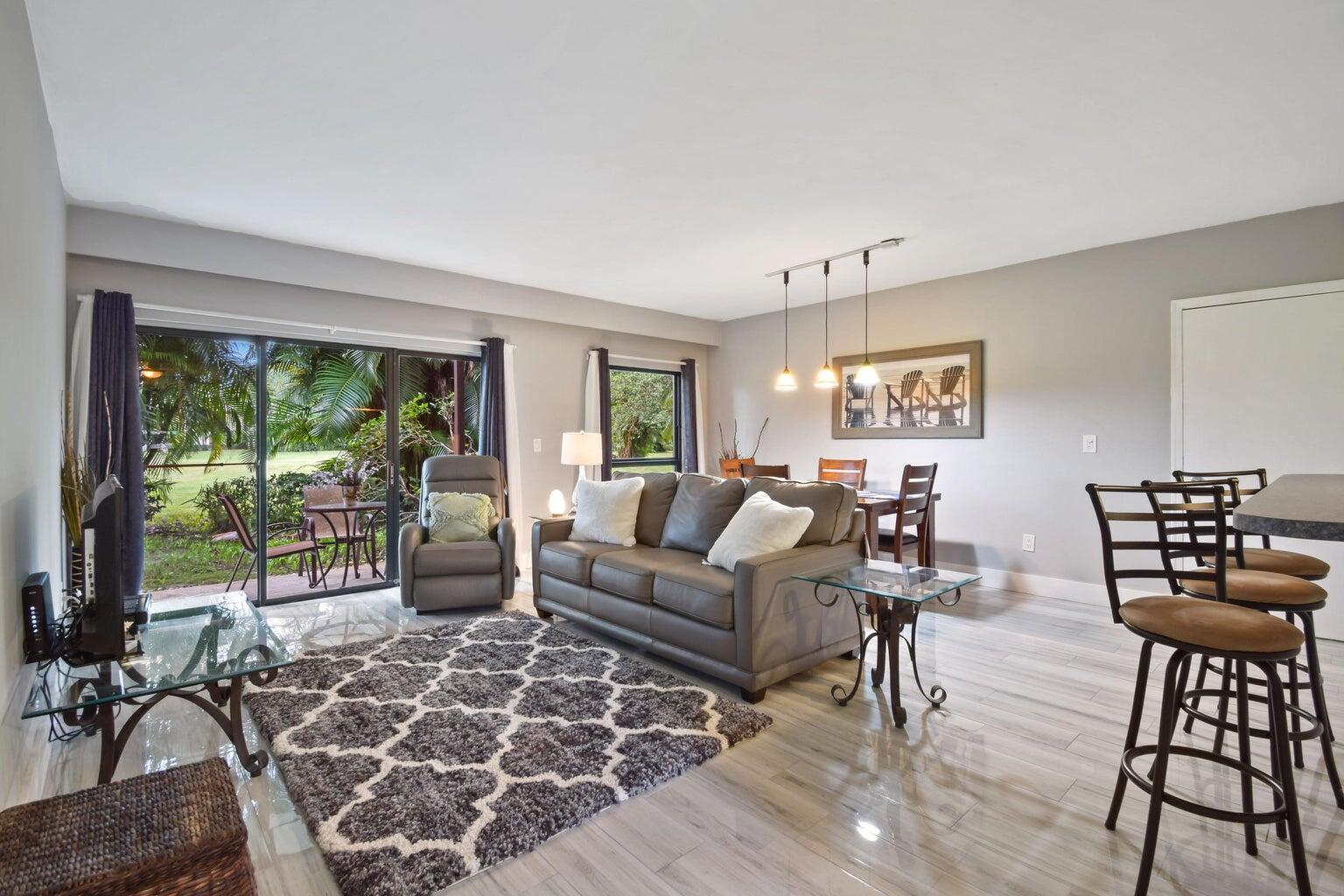 a living room with furniture and a floor to ceiling window