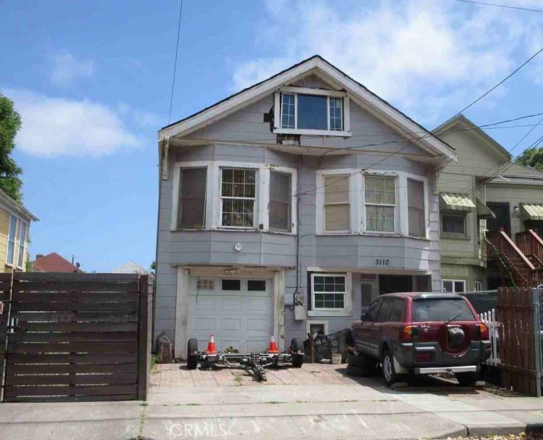 a front view of a house with parking