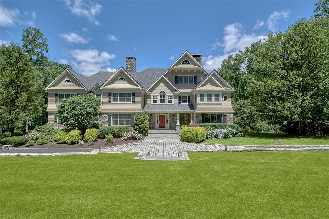 a front view of a house with a garden and plants