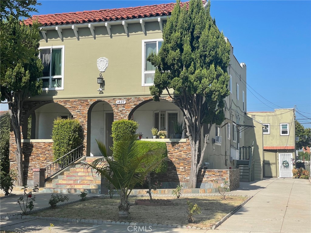 a front view of a house with garden