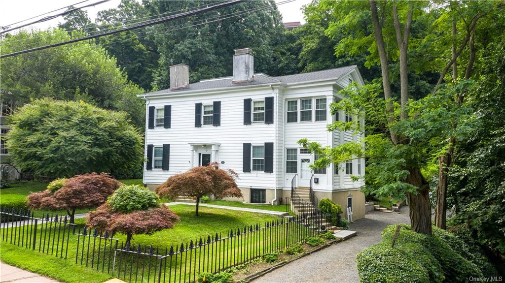 a aerial view of a house with yard and lake view